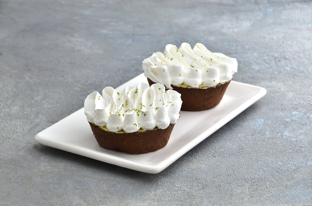 Lima Pie individual con masa sablée de chocolate, relleno de chocolate blanco y picos de merengue italiano con ralladura de lima fresca de Mada Patisserie en Belgrano.